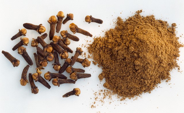 Cloves and Powdered Cloves --- Image by © Maximilian Stock Ltd/photocuisine/Corbis